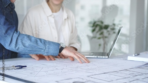 Konstfotografi Architects and engineers collaborating on a technical blueprint, discussing cons