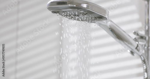 Obraz na plátně Water flows from showerhead in bathroom during morning routine inside a home
