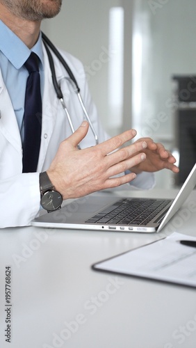 Cuadro en lienzo Doctor in white coat showing test results to patient on tablet during consultation