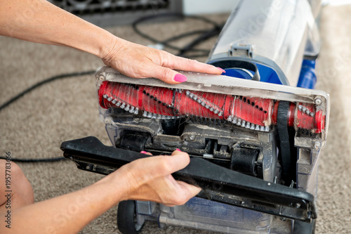 Women taking apart vacuum
