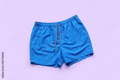 Swimming trunks on lilac ba...