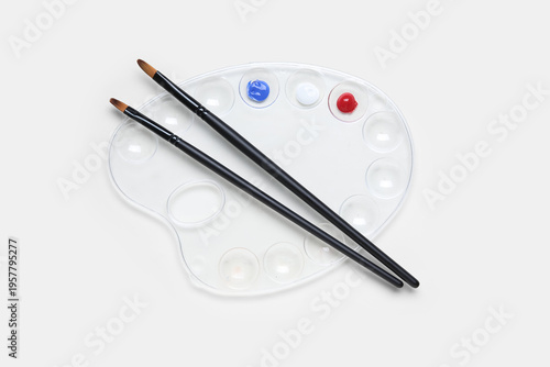 Palette with paints in colo...