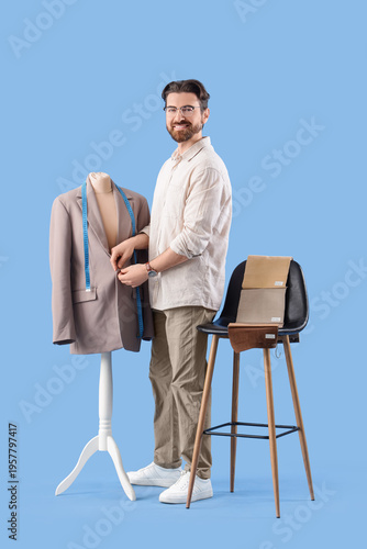 Male tailor buttoning jacke...