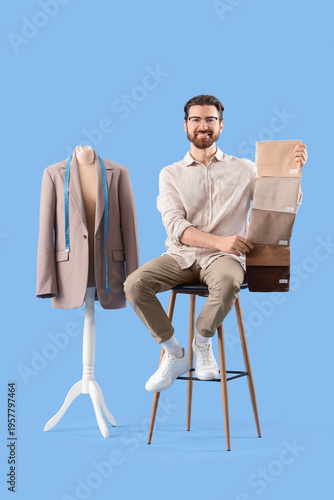 Male tailor with fabric sam...