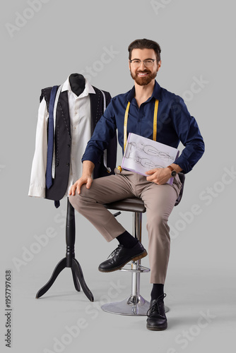 Male tailor with sketch and...