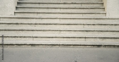Runner is sprinting into frame across path by stone staircase, and people are walking toward steps