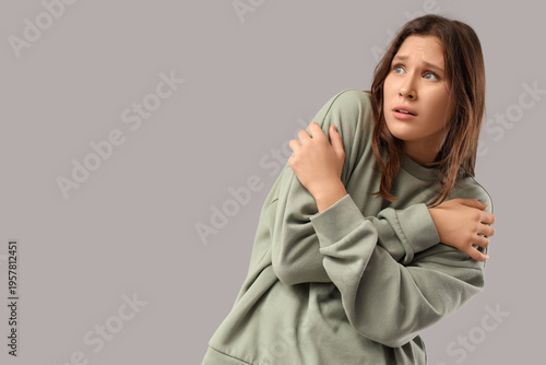 Scared young woman on light...