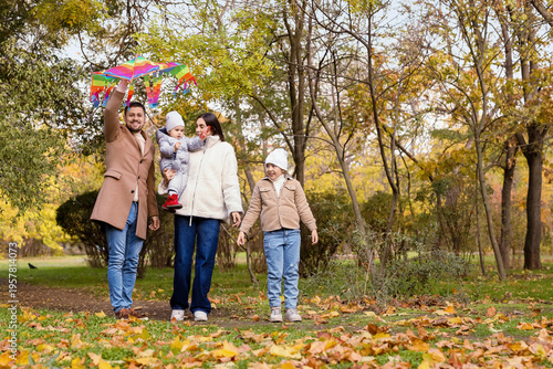 Happy family flying kite in...