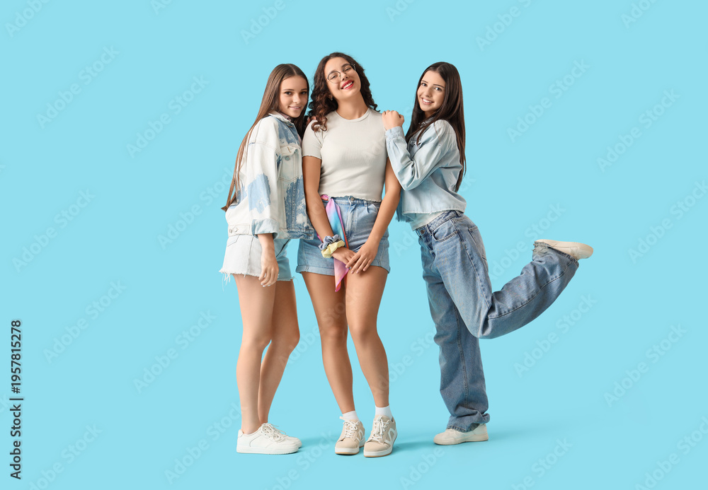 Obraz premium Happy teenage girls on blue background