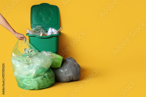 Woman with full garbage bag...