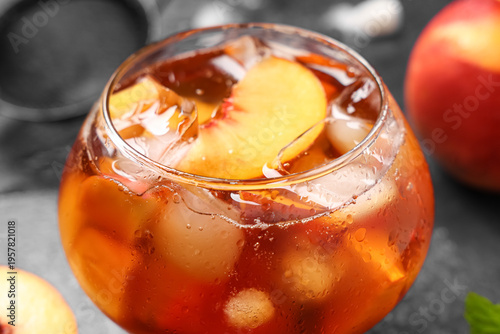 Glass of cold tea with peac...