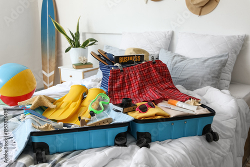 Open suitcase with men's sw...