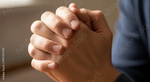 Close up of clasped hands showing a gesture of hope and contemplation