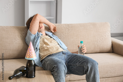 Young man with hangover and...