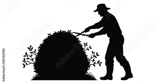 Gardener trimming a large bush with shears a striking silhouette