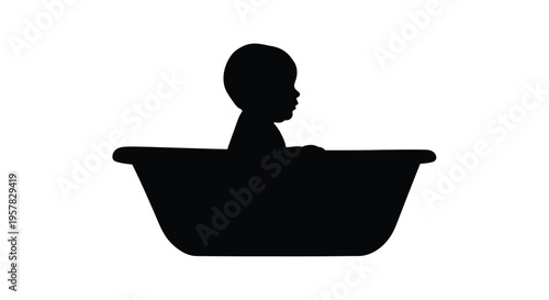A baby sits in a bathtub depicted in stark black silhouette