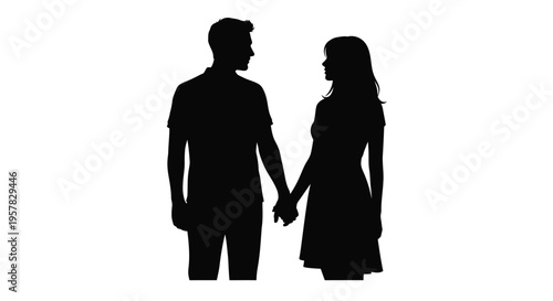 Couple holding hands facing each other in a dark silhouette