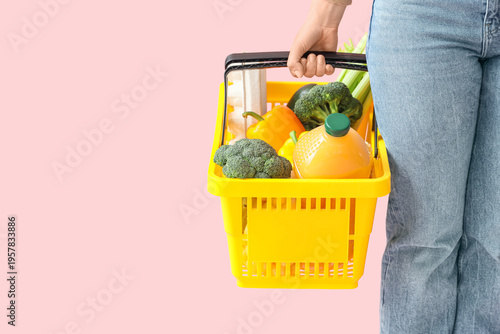 Woman holding yellow shoppi...