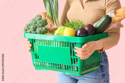 Woman holding green shoppin...