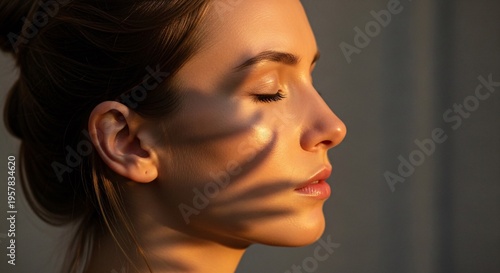 beautiful young woman with closed eyes and palm leaf shadows on face