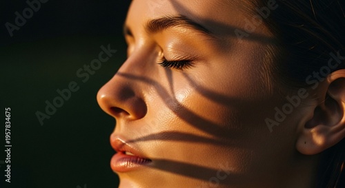 beautiful young woman with closed eyes looking at shadows on face isolated on grey