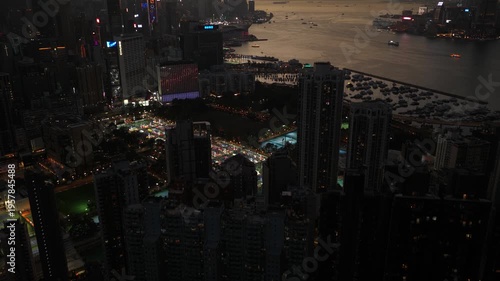 Wallpaper Mural Aerial view of hong kong's illuminated cityscape and victoria harbour as morning fog rolls through the skyscrapers at sunrise, revealing the iconic urban landscape and mountains in the background Torontodigital.ca