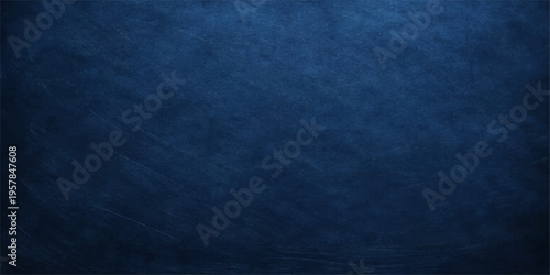 A dark blue grunge background with a vintage denim fabric texture and rough paper material design creates a dirty textured canvas wallpaper for a blank backdrop