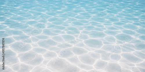 Clear turquoise waves ripple across the blue water surface of a summer swimming pool creating an abstract liquid texture with nature's reflection on the wet aqua ocean-