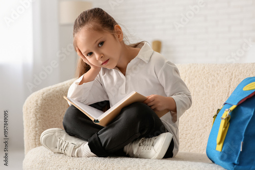Tired little girl with book...