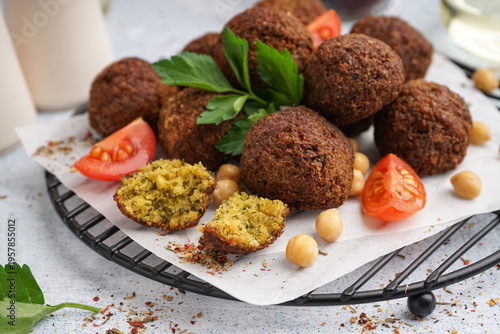 Schilderij op canvas Stand with delicious falafel balls, chickpea and tomato on light background, clo