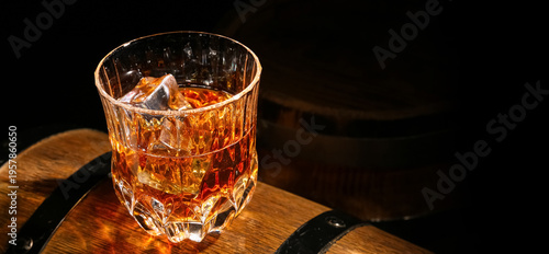 Glass of cold whiskey on wo...