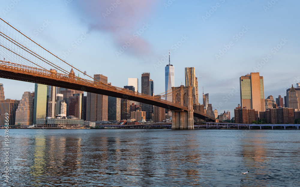 Fototapeta premium Urban architecture of New York city view. Brooklyn bridge of New York city. Brooklyn landmark. Manhattan cityscape with skyscraper architecture. Brooklyn bridge to Manhattan