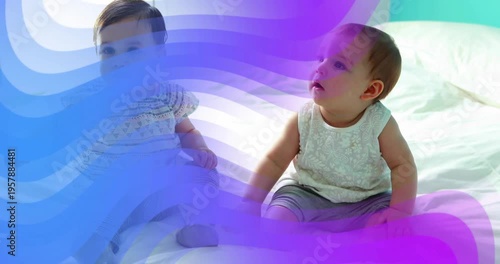 Left baby reaching right baby, seeking touch while purple overlay sweeping over babies for parents