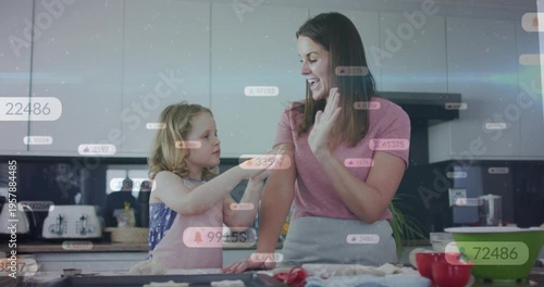 Mother and daughter cooking, child offering dough sparking bonding high-fives with bubbles on hands