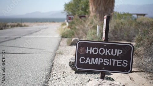 Signs showing hookup campsites for visitors at the Salton Sea Recreation Area in California along the road leading to the campground