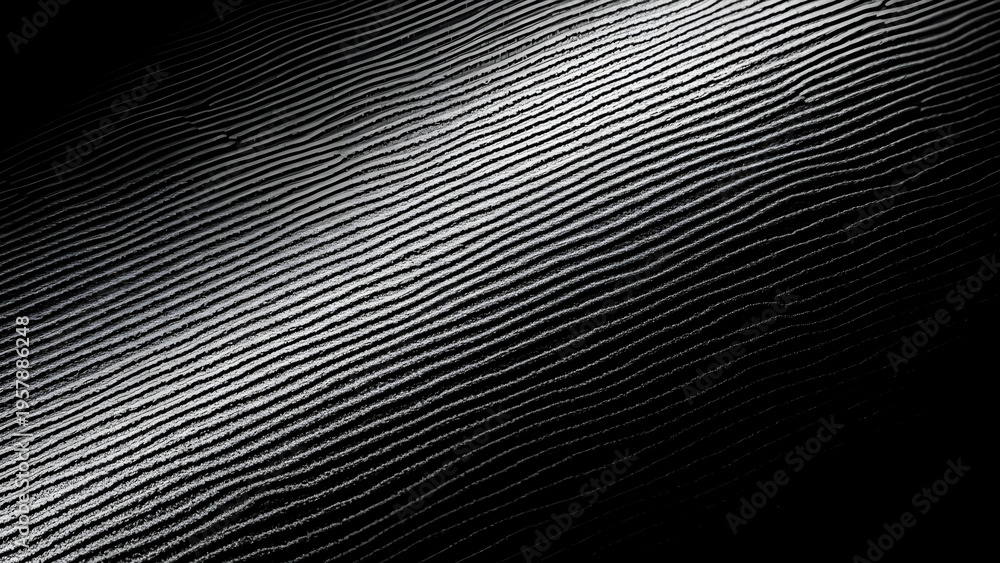 Obraz premium A close-up view of a shiny surface with a gradient light reflection.
