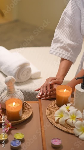 Spa setup with herbal compress candles flowers and relaxing wellness mood.