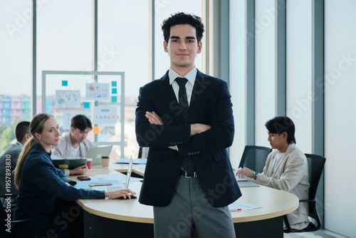 Portrait of confident Hispanic businessman, business CEO president, cheerful, arms crossed, and looks at camera in executive meeting with coworker team in conference office, successful investment.