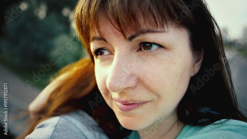 portrait of a happy woman in nature looking around, woman enjoying a summer day, have fun and enjoy
