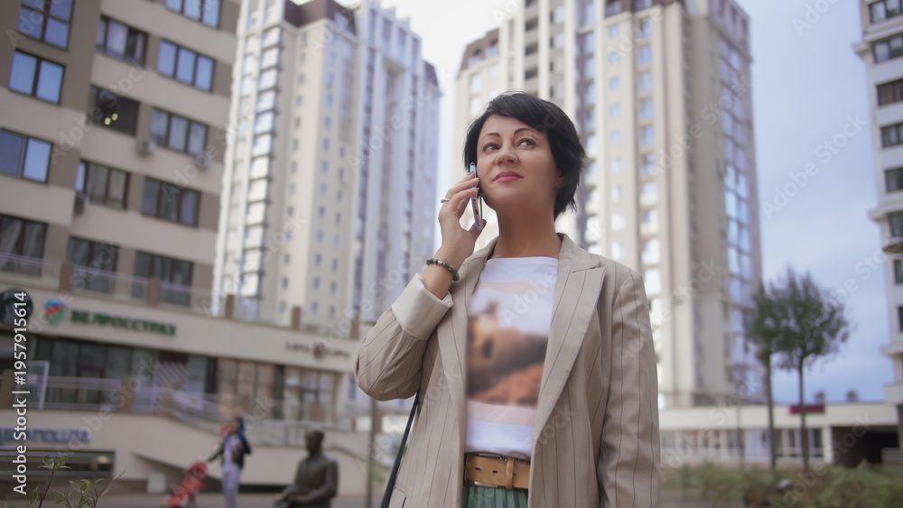 Fototapeta premium Businesswoman Talking on Phone in Urban Area, have fun and enjoy