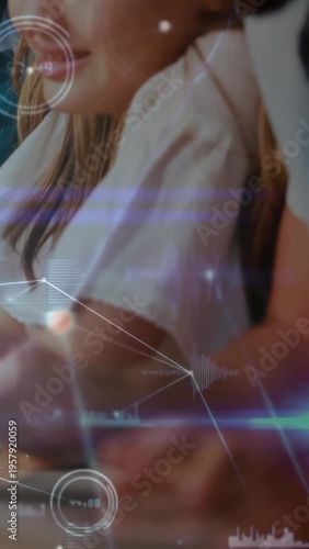 Vertical video: Girl tapping tablet keys for learning in study, HUD growing and highlighting graphs