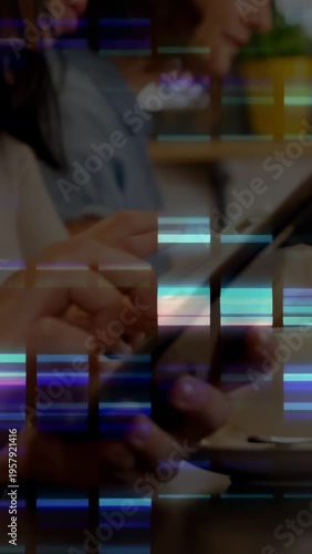 Vertical video: Hands tapping phones and tablet at cafe, sharing on mobile tech with glitch overlay