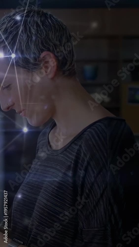 Vertical video: Woman looking down, raising wrist, tapping watch, net pulsing over wrist for tech