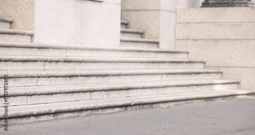 Diverse passersby commuting past steps as hand passing camera showing runner sprinting with bags