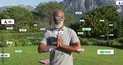 Wellness coach praying purple-mat badges emerging at edges gathering around him, showing growth