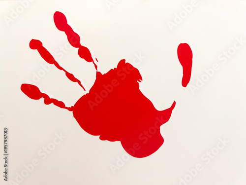 Coloured handprints are imprinted on the wall.