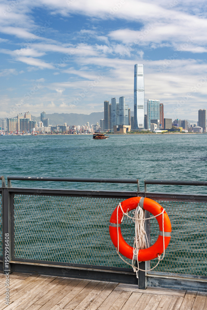Fototapeta premium Hong Kong skyscraper panorama on a sunny day with water and boats