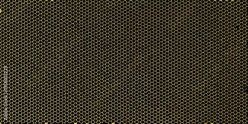 Close up of a yellow honeycomb structure against a dark background
