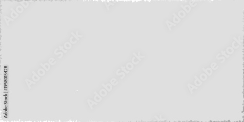 A plain grey background with a small blurry white shape