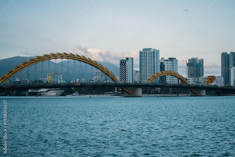 Obraz premium Dragon Bridge crossing Han River in Danang at sunset, iconic Vietnam city landmark, Famous Dragon Bridge cityscape in Da Nang during twilight